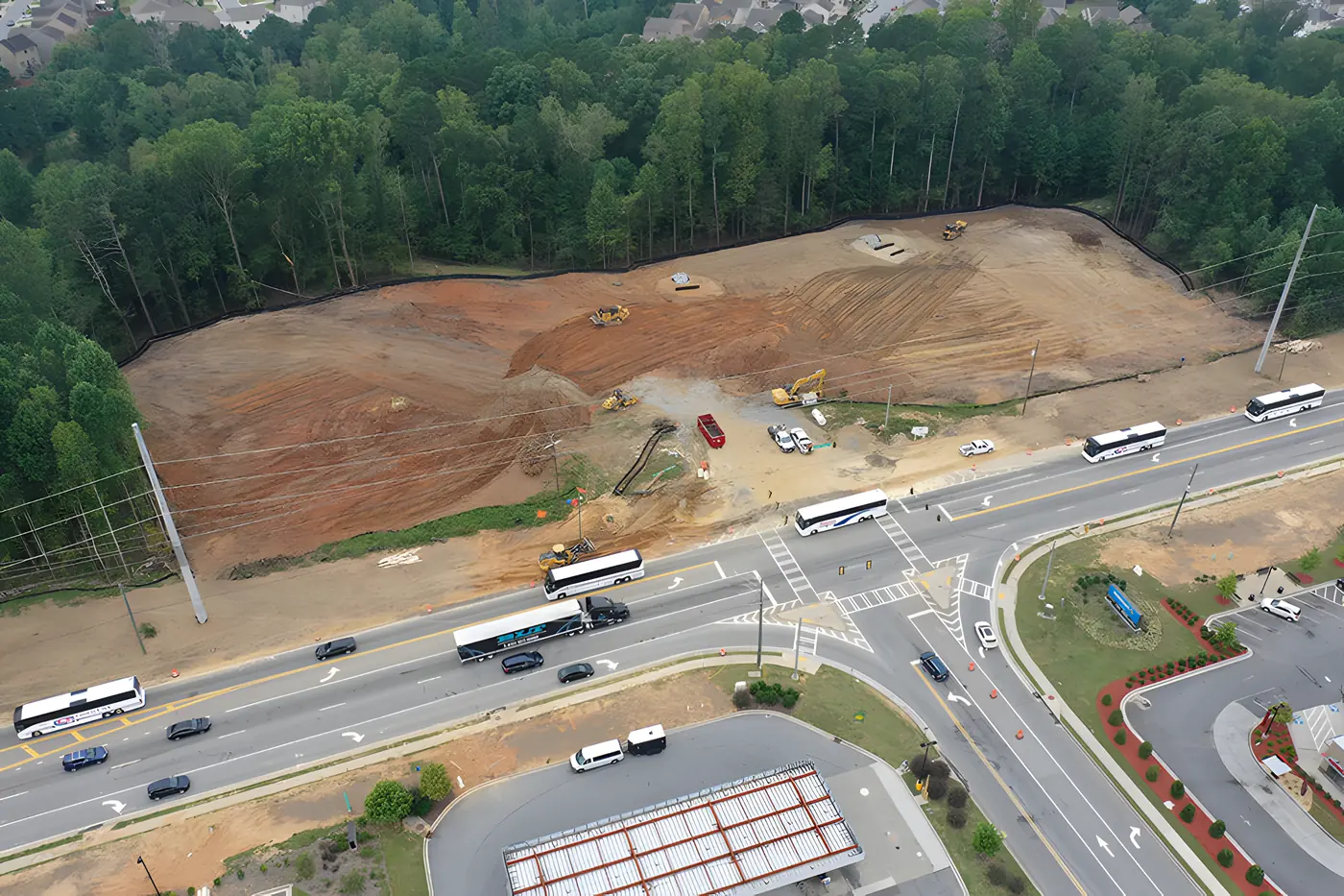 Aerial view of site work underway at a hard corner